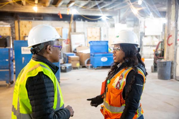 CHA CEO Tracey Scott (left) speaks with Jamara Fleming 
