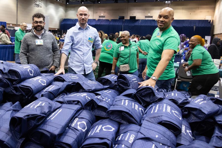 CHA Volunteers in front of supply packs for Operation Warm 2024