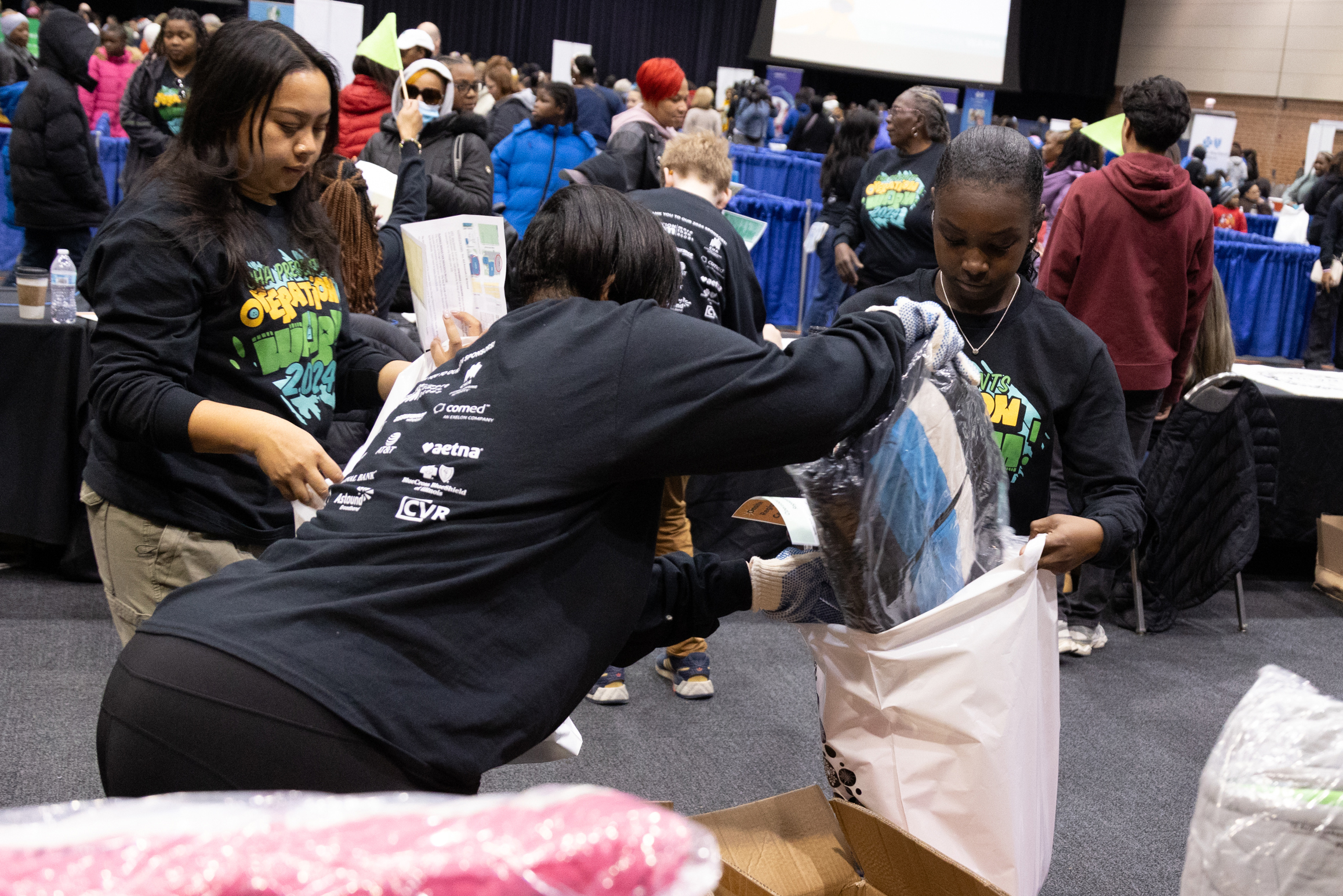 CHA Volunteers filling supply packs.